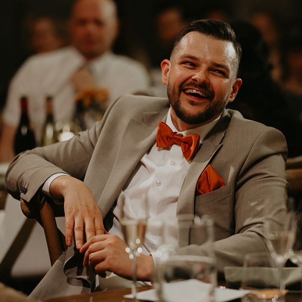 wedding-guests-at-wedding-breakfast-in-different-coloured-suits.
