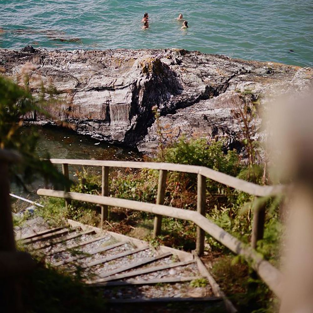 Stairs leading to private beach for a natural swim, wellness hen do idea at Polhawn Fort