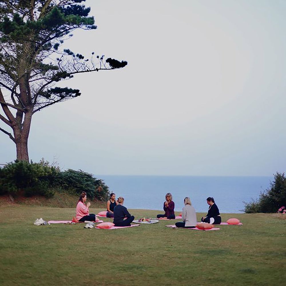 Outdoor morning yoga for wellness hens at Polhawn Fort