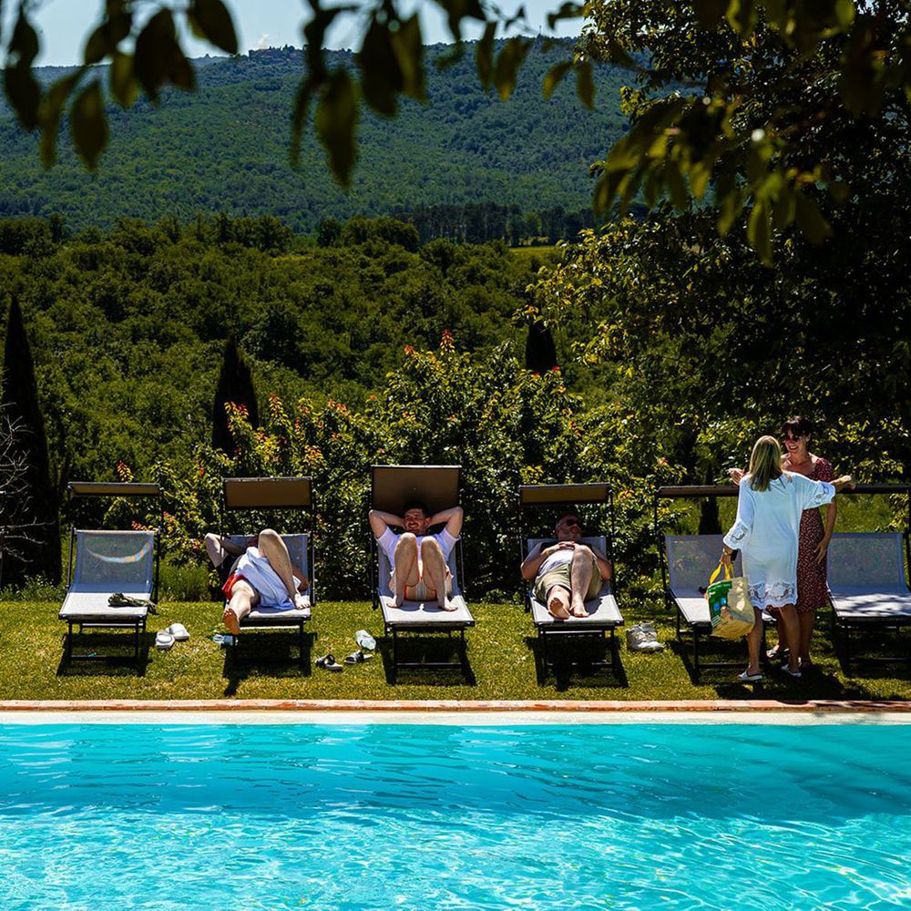Wedding party by pool for wellness hen do outdoors