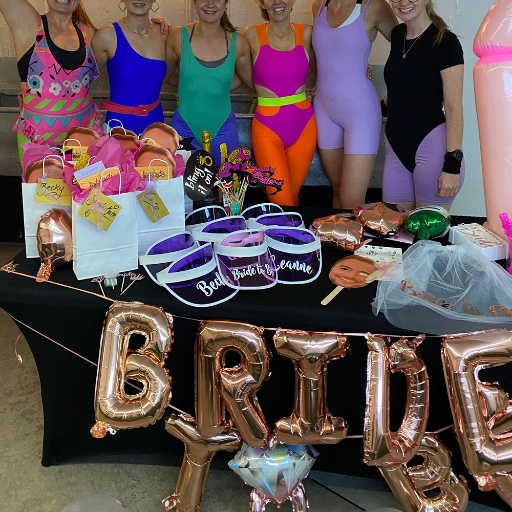 Bridal party wearing colourful lycra outfits for healthy hen do at Digme Fitness spin class