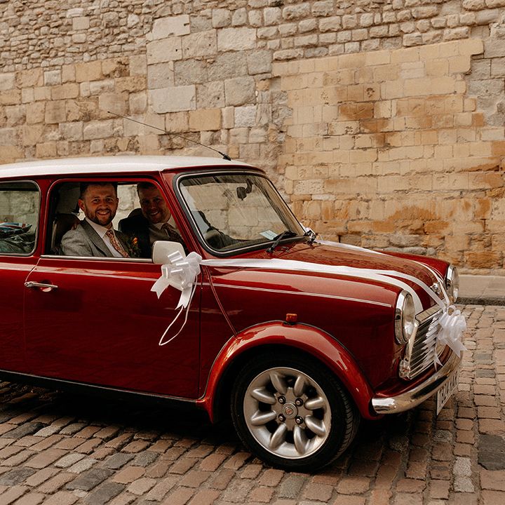 grooms-in-red-mini-wedding-car-transport