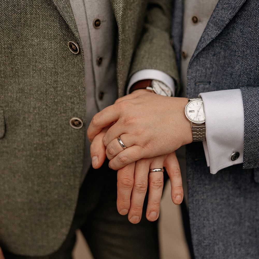 grooms-wearing-platinum-wedding-rings-with-silver-watches