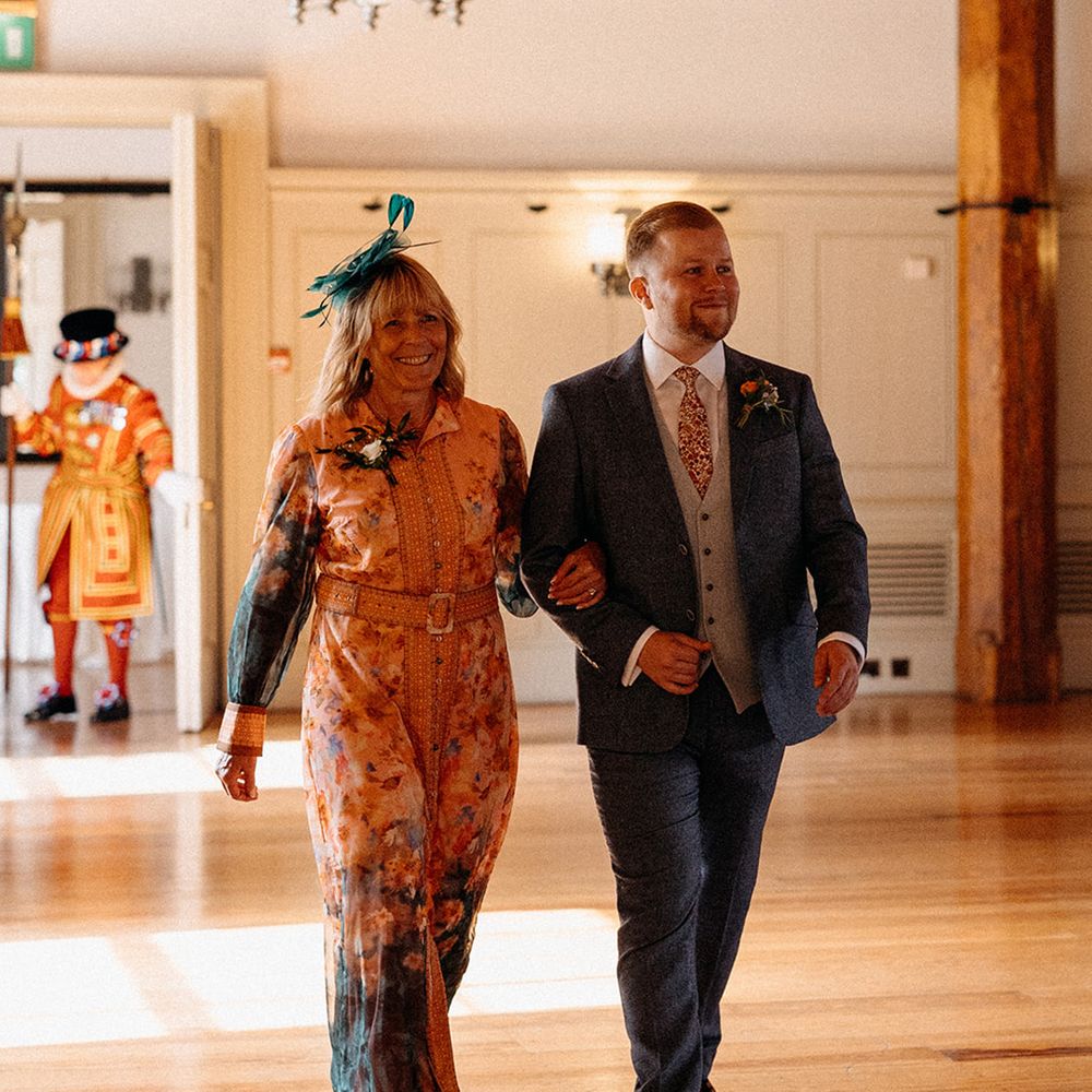 mother-of-the-groom-walks-groom-down-the-aisle