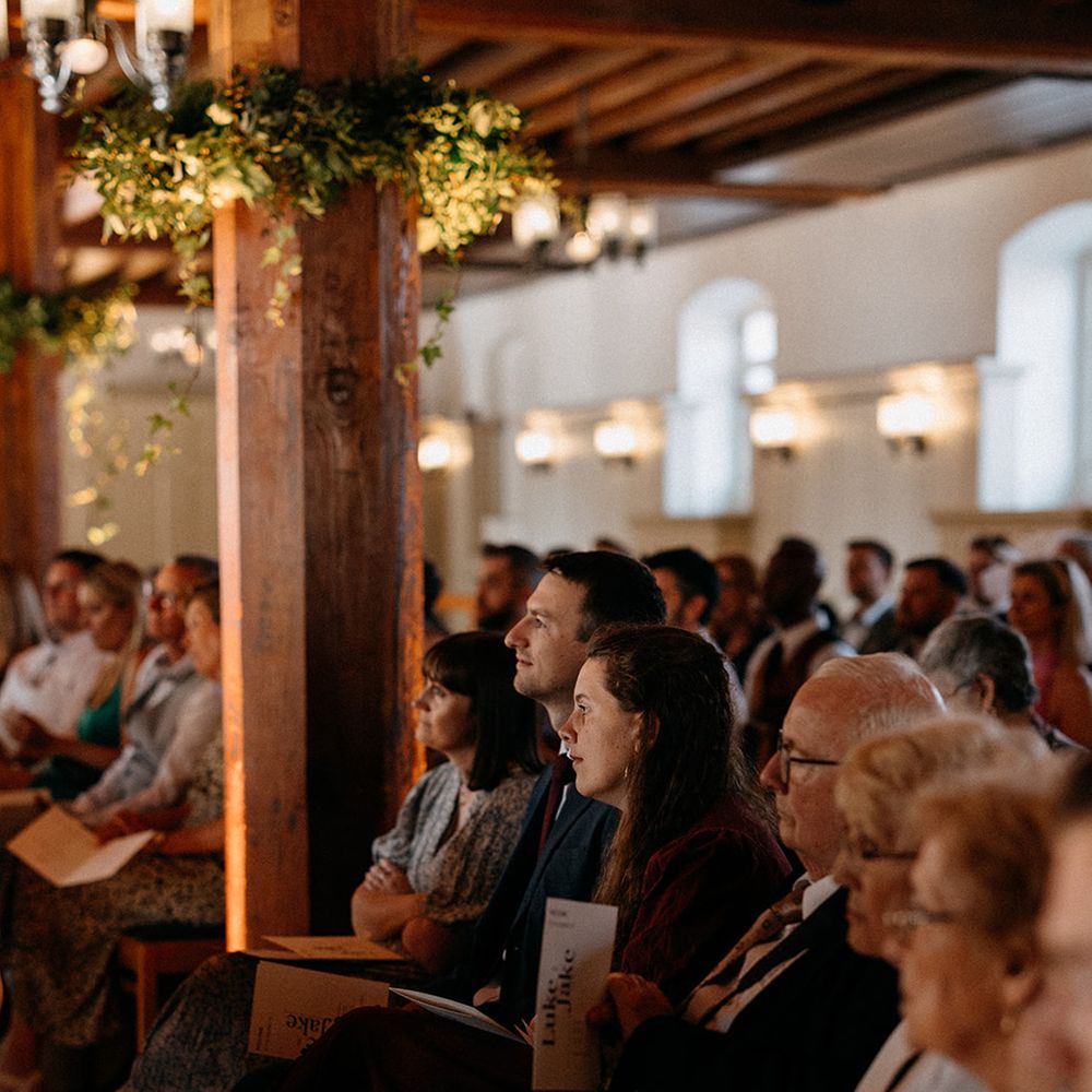 wedding-guests-listening-to-same-sex-wedding-ceremony