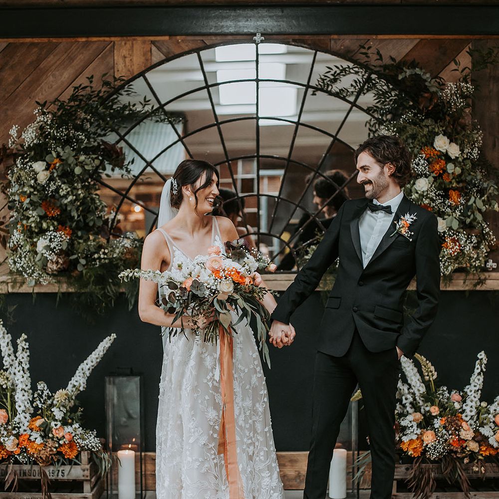 Bride in wedding dress and groom in black tuxedo at Lake District wedding
