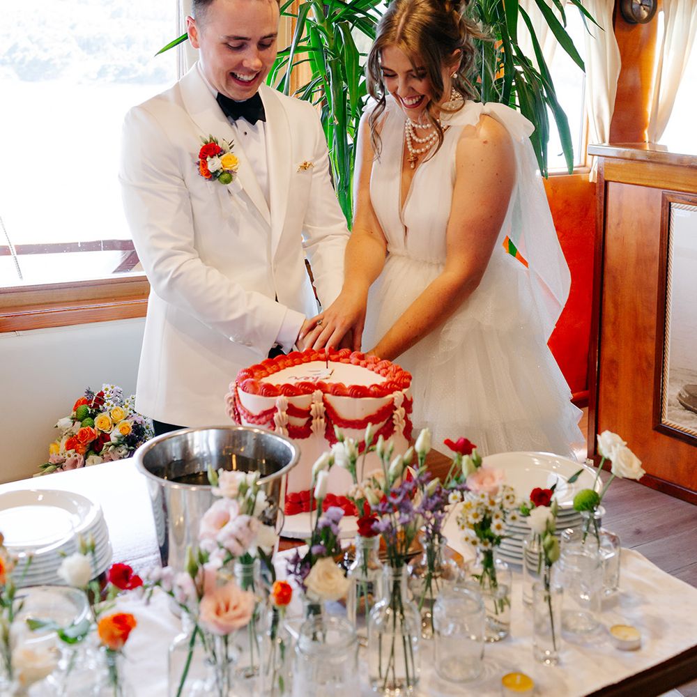 bride-and-groom-cut-heart-shaped-wedding-cake