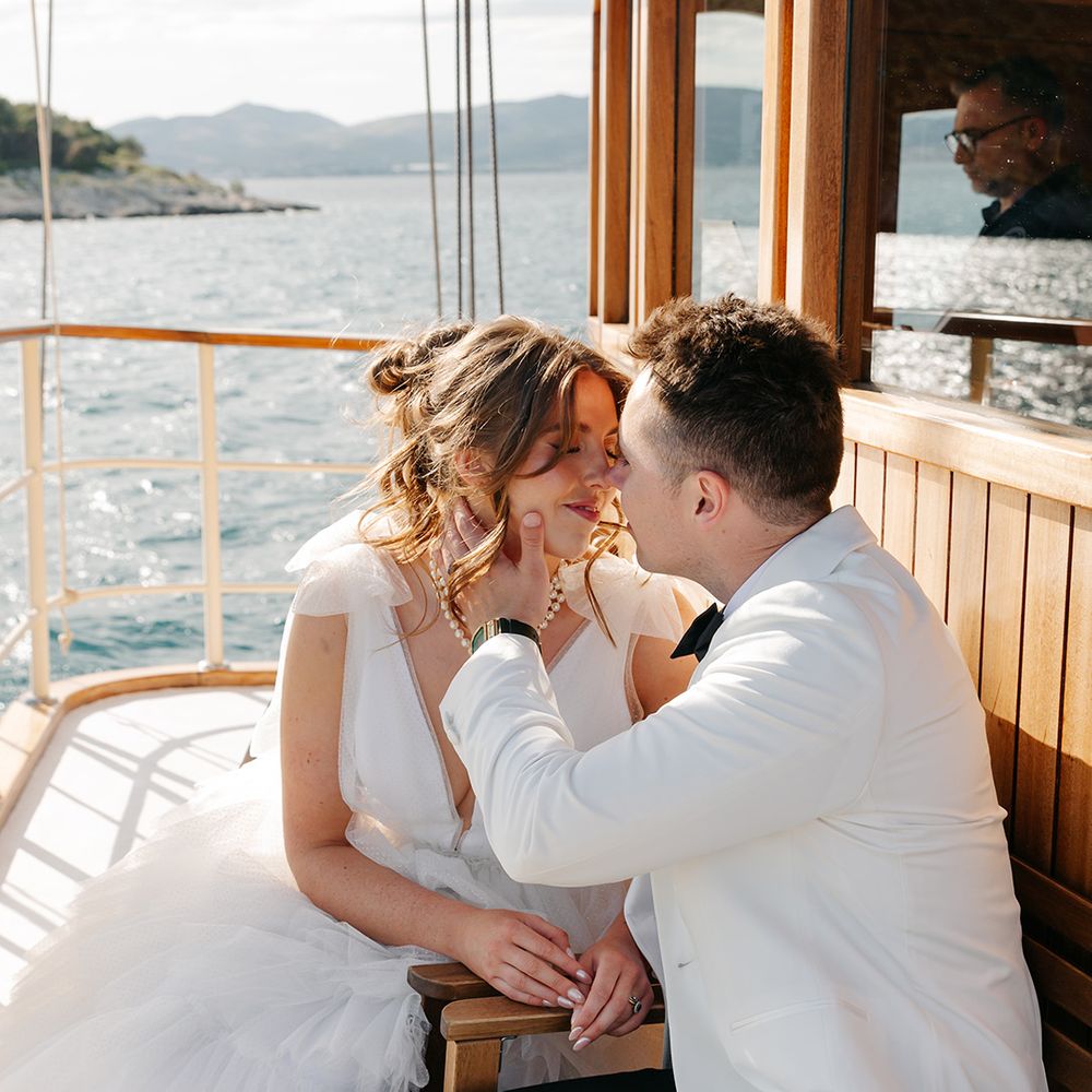 Couple shares intimate kiss on boat