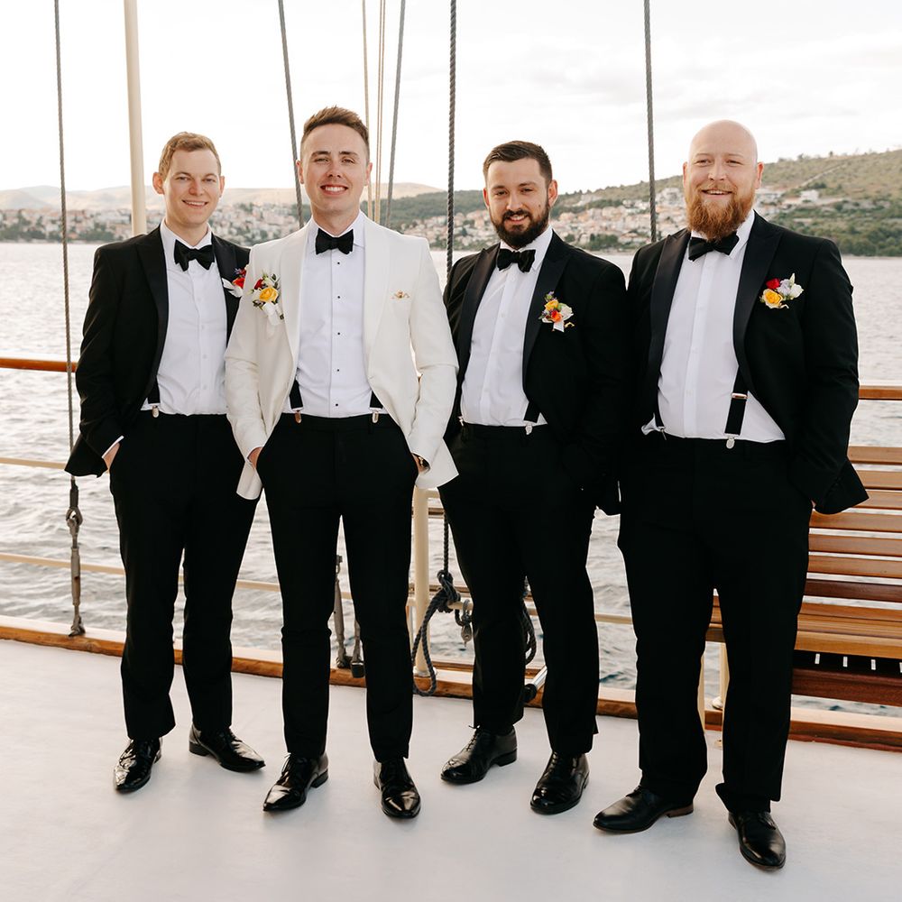 Black tie wedding dress code with groomsman in black tuxedo