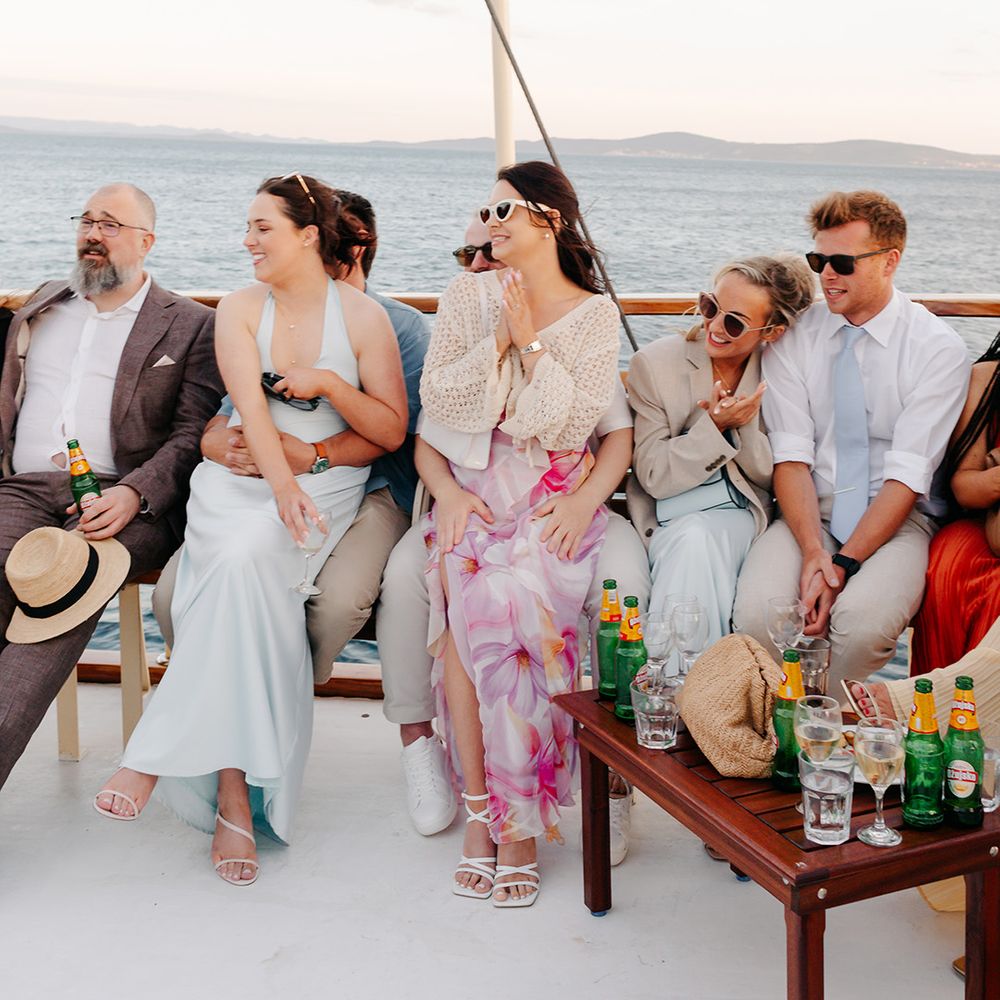 Wedding guests chatting on boat