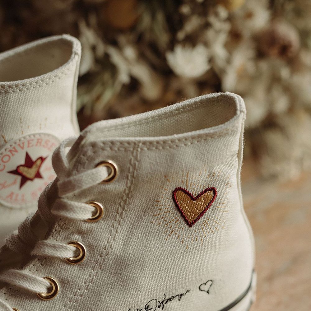 Personalised white Converse for the bride with her new signature and yellow and red embroidered hearts