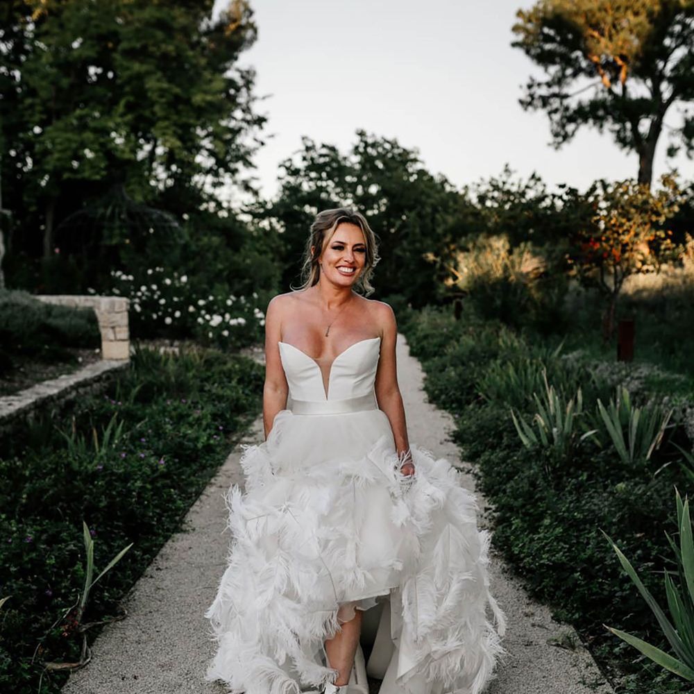 White bridal boots with feather wedding dress