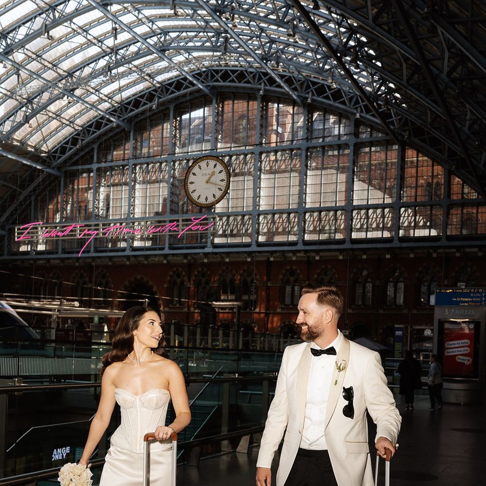 bride-and-groom-walking-with-their-suitcases