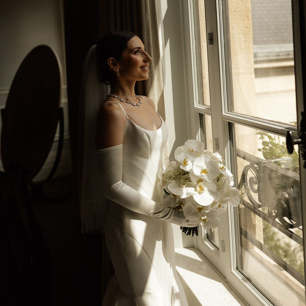 bride-carrying-white-orchid-wedding-bouquet