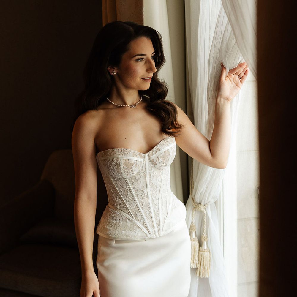 bride-getting-ready-for-wedding-in-lace-corset-with-satin-mini-skirt