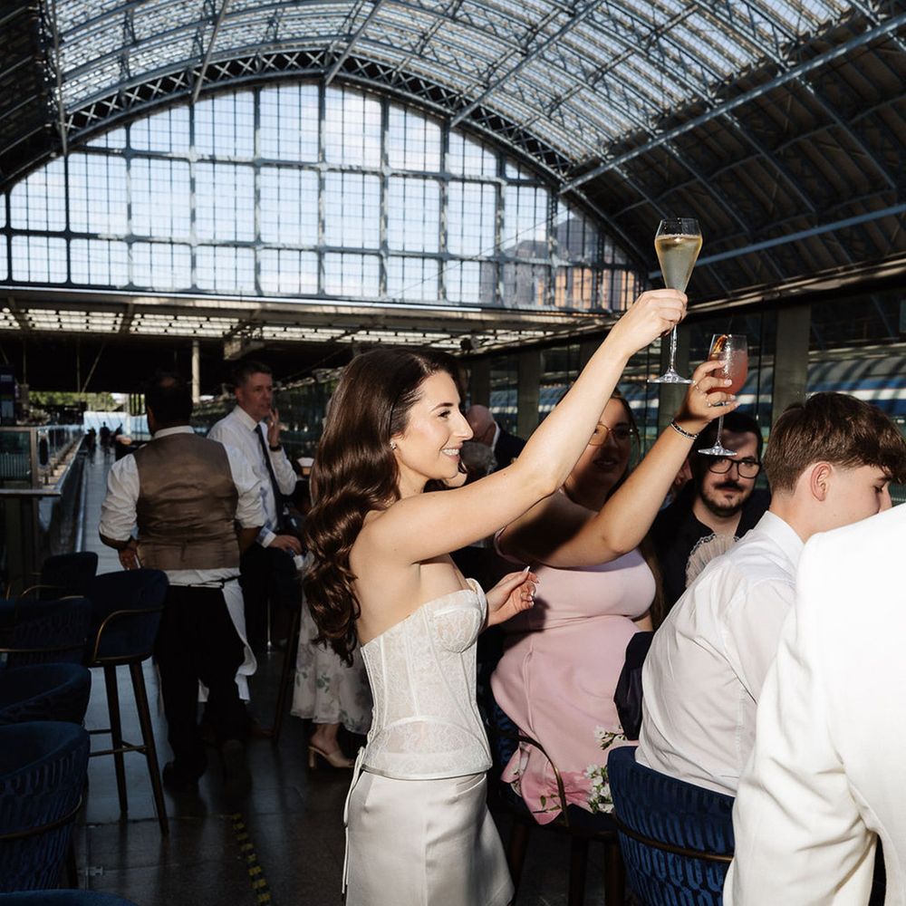 Bride raises a glass in toast