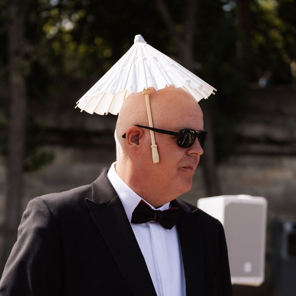 Funny wedding guest with mini umbrella 
