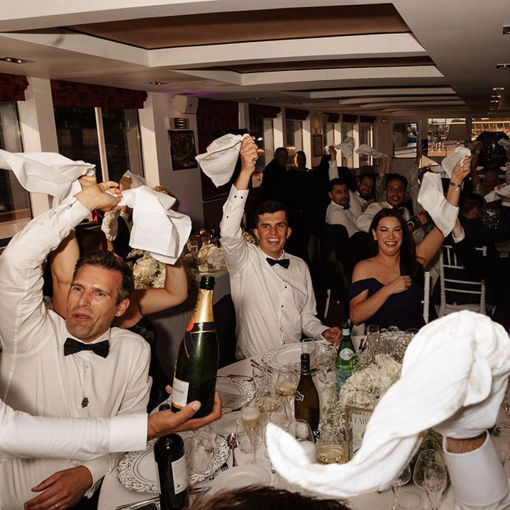 guests-wave-napkins-for-wedding-entrance