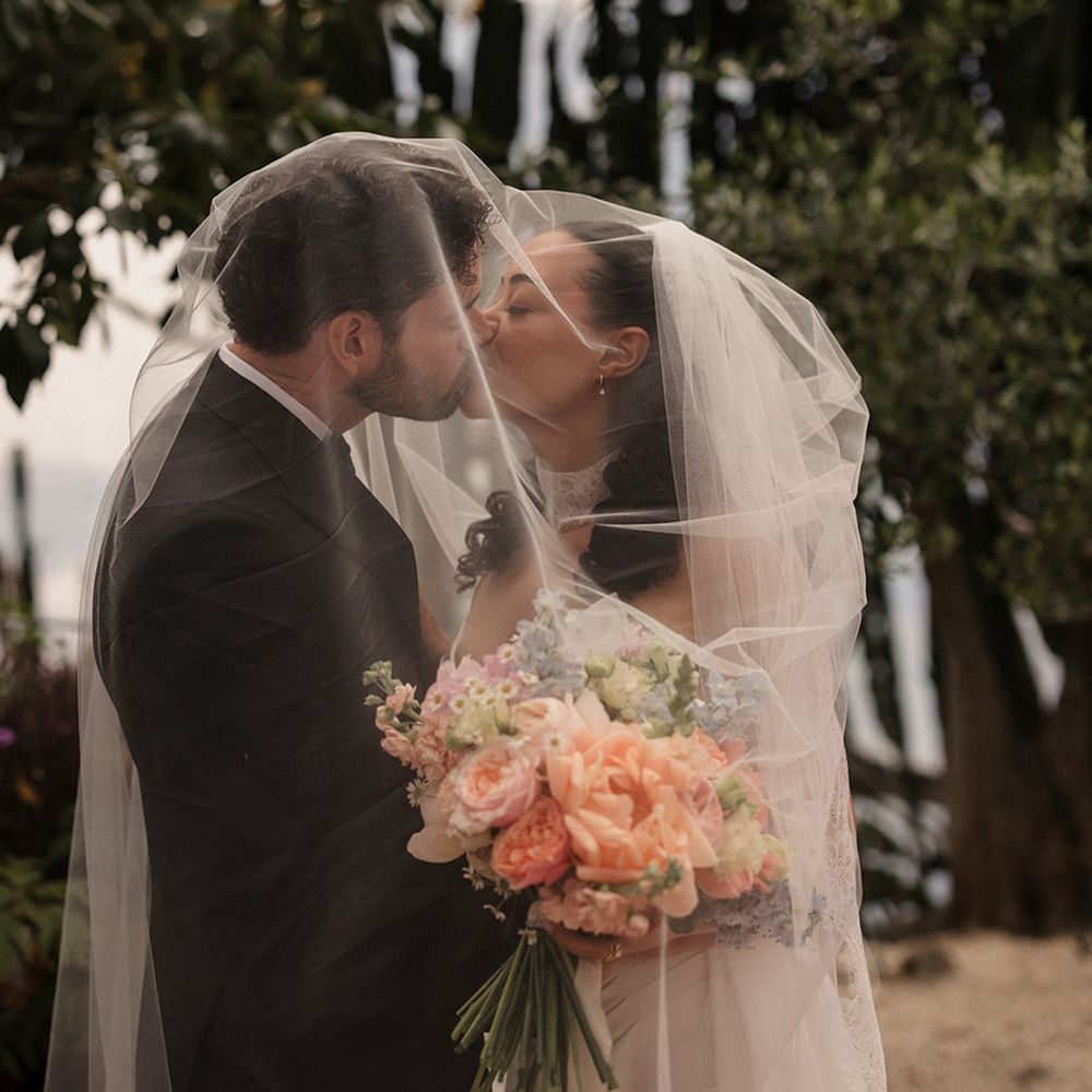 bride-and-groom-kiss-under-wedding-veil