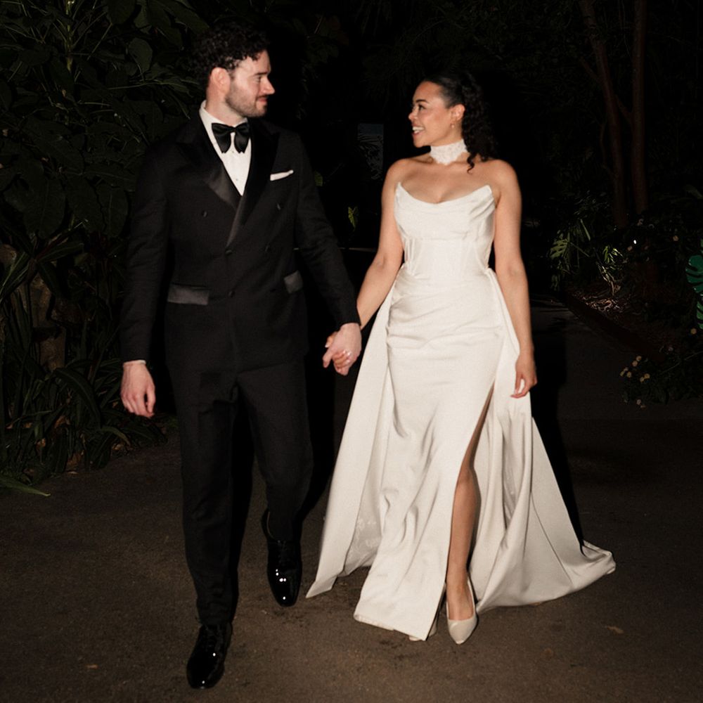 flash-photography-of-groom-in-black-tuxedo-and-bride-in-corset-wedding-dress