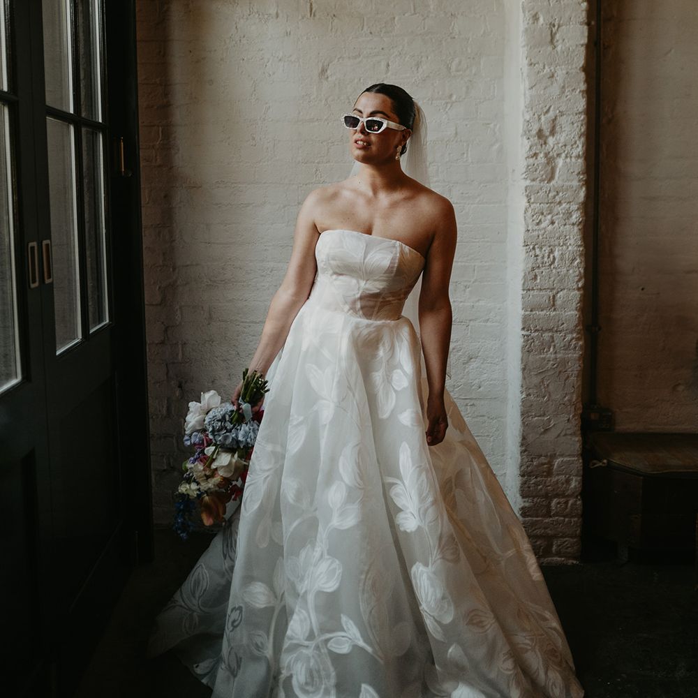 bride-in-strapless-floral-pattern-wedding-dress-with-white-sunglasses