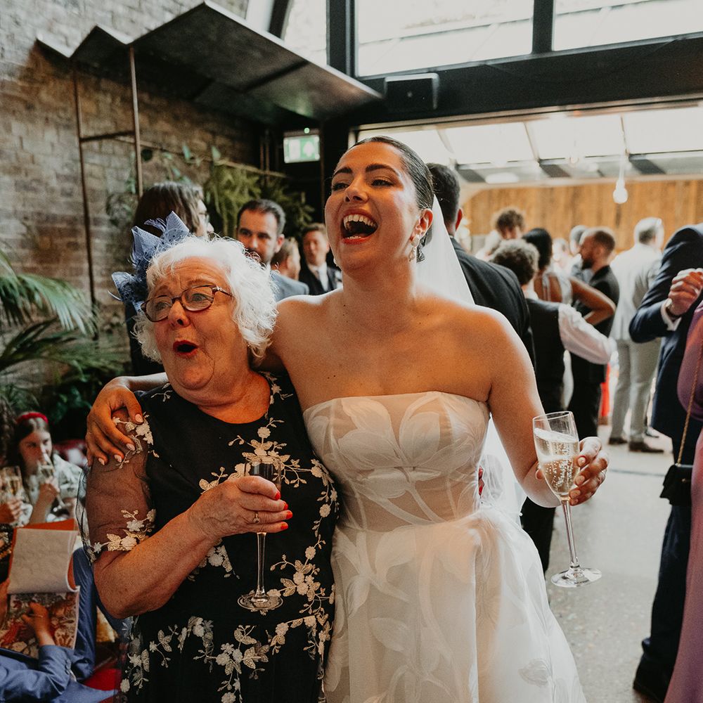 bride-in-strapless-floral-wedding-dress-with-wedding-guest