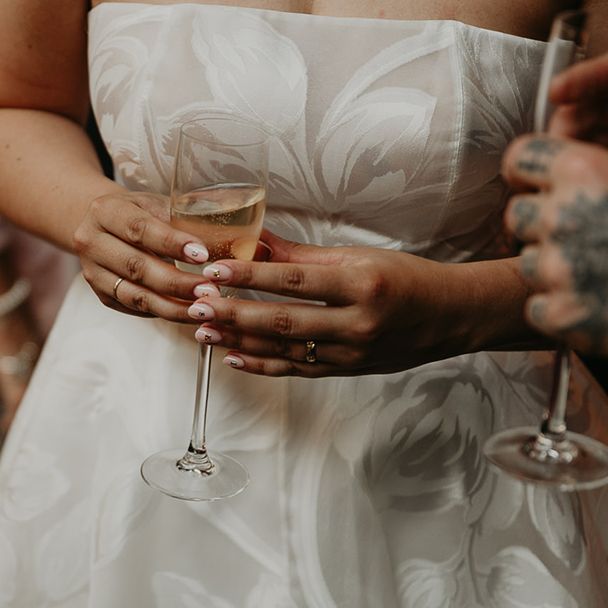 bride-with-sparkly-nail-art-decals-with-light-pink-almond-shaped-wedding-nails