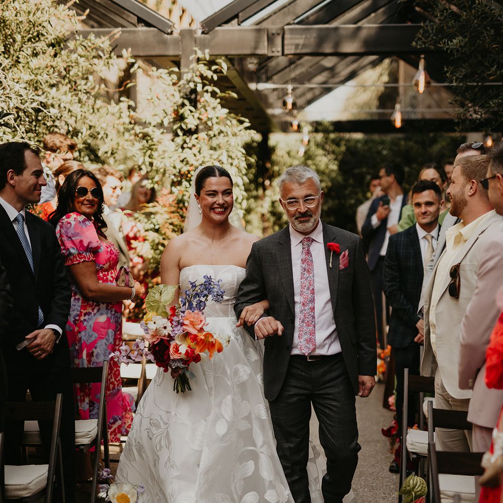 father-of-the-bride-walking-bride-down-the-aisle-at-outdoor-wedding
