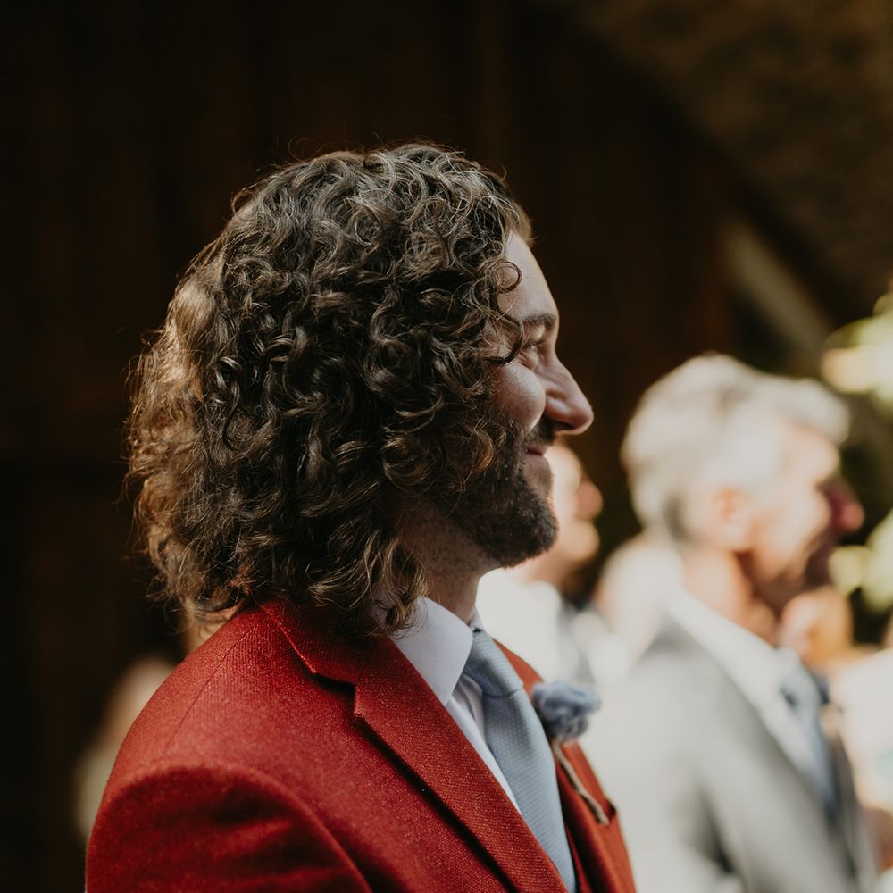 groom-sees-bride-for-the-first-time-in-dark-red-wedding-suit