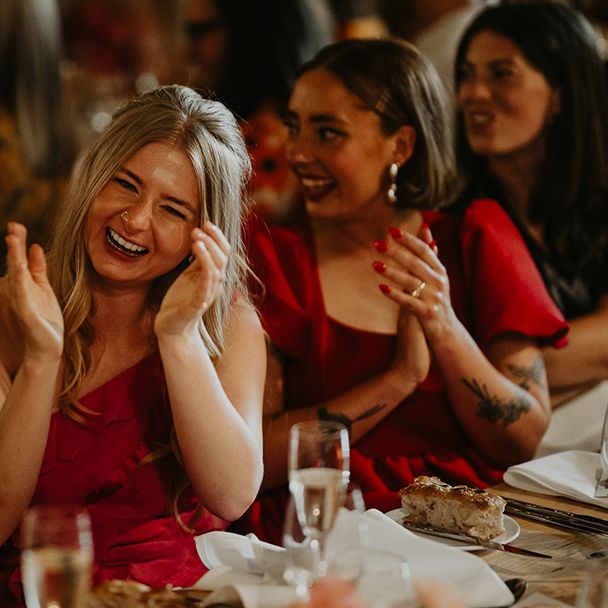 Wedding guests laughing at wedding speeces