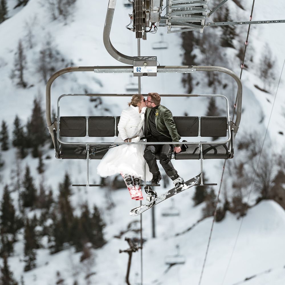 ski-lift-at-winter-wedding-as-couple-kisses