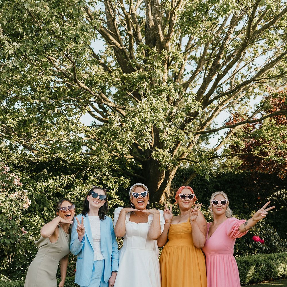 bridal-party-wearing-pastel-coloured-bridesmaid-dresses