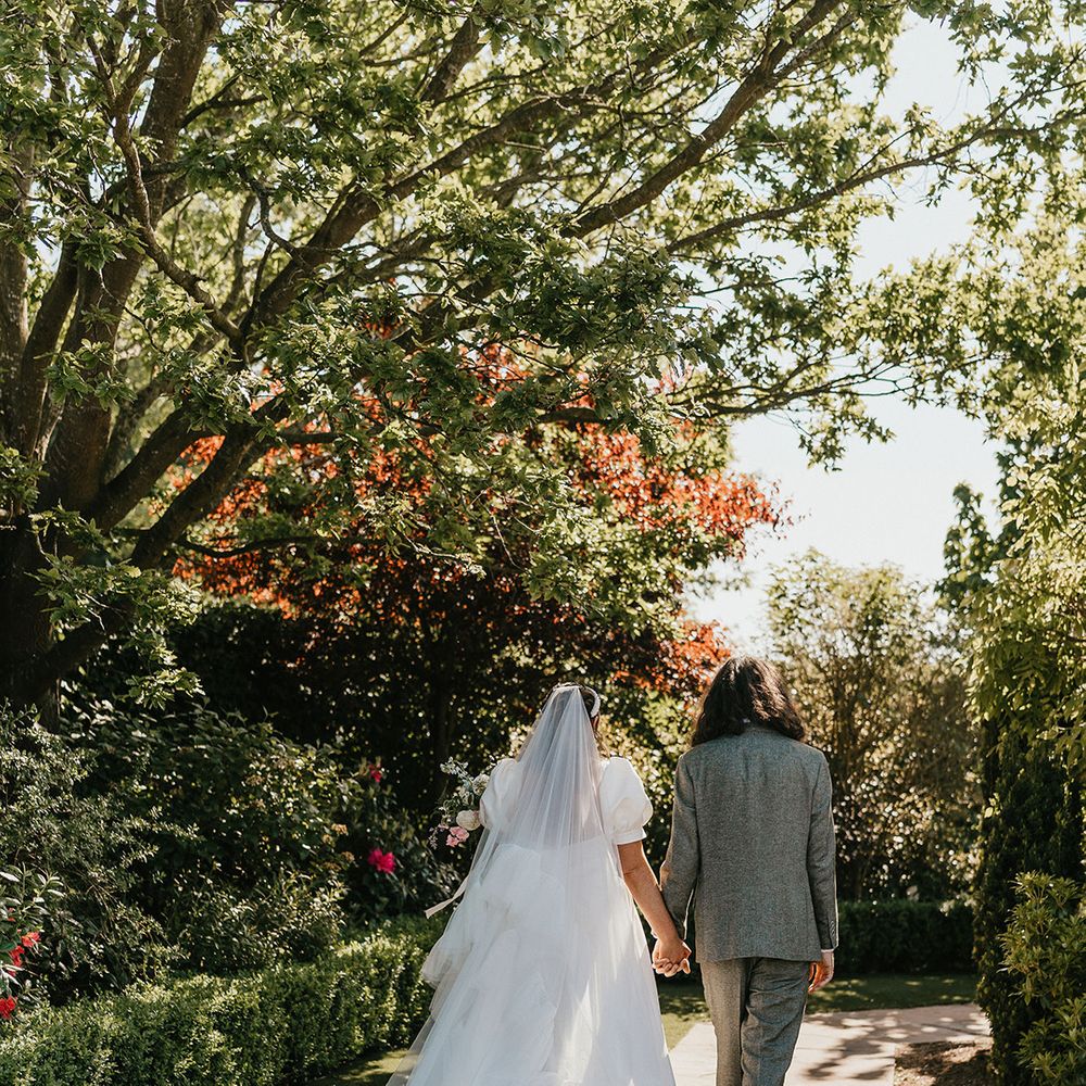 bride-wears-white-wedding-dress-and-ruffle-veil
