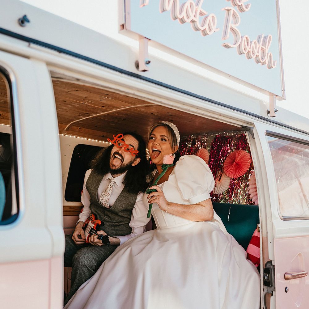 couple-take-photos-in-pink-photobooth-camper-van