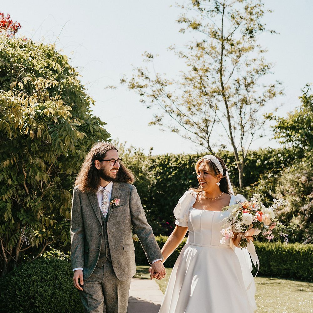 groom-in-green-wedding-suit-and-bride-in-puff-sleeve-wedding-dress