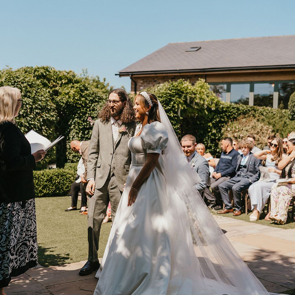 outdoor-wedding-ceremony-with-bride-in-puff-sleeve-wedding-dress