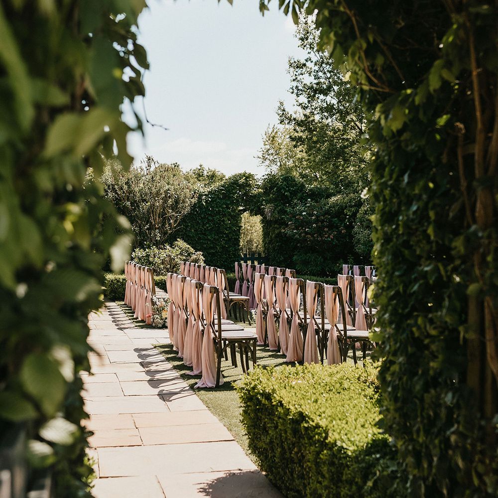 outdoor-wedding-ceremony-with-pink-chair-decor