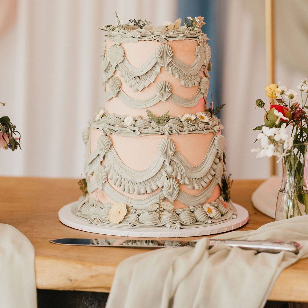 two-tier-retro-wedding-cake-with-sage-green-frosting