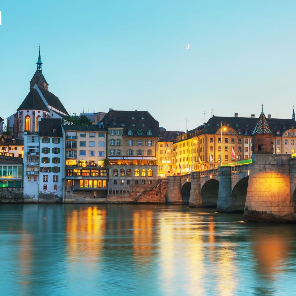Switzerland at dusk with city lights reflecting on water