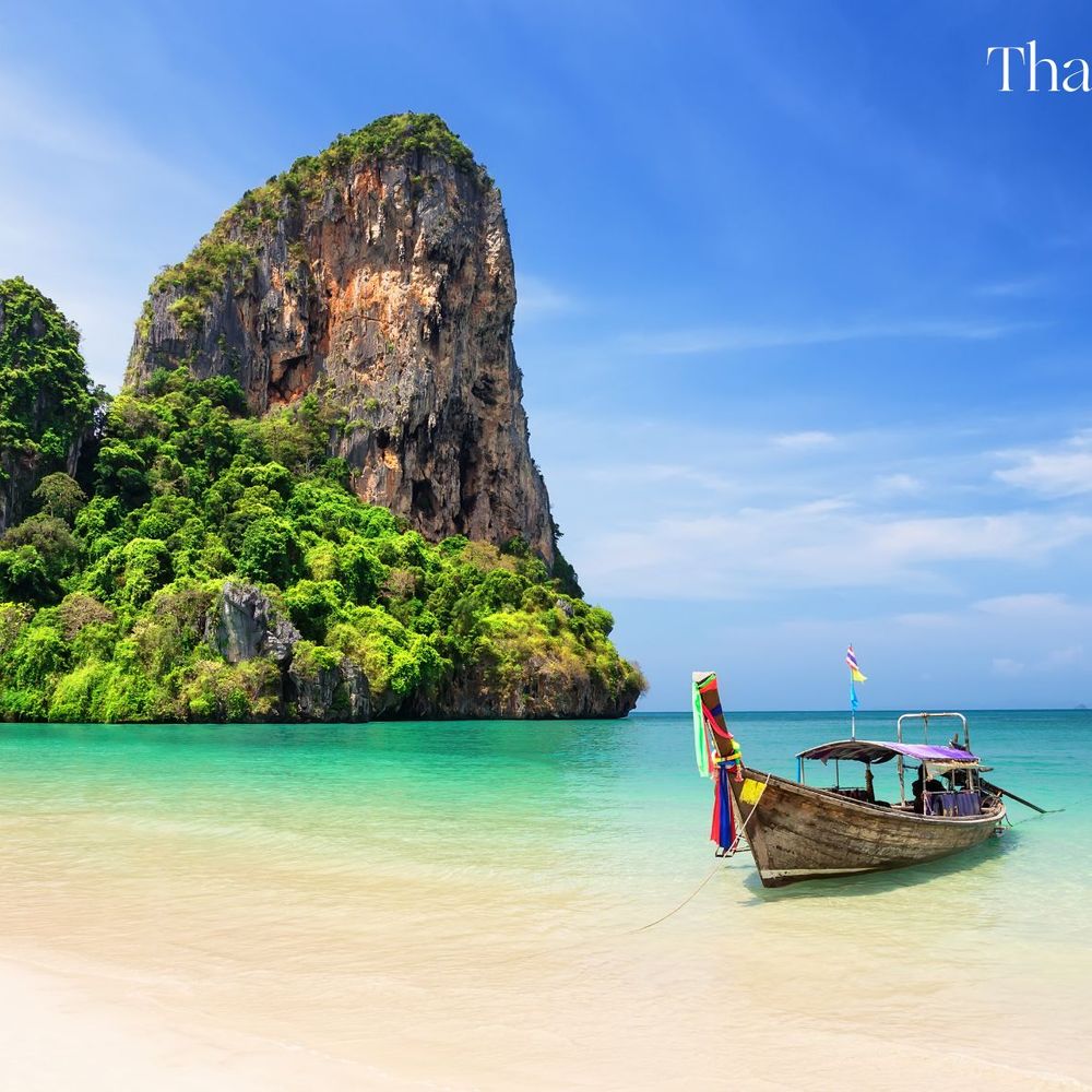 Thailand beach with docked boat in the sea
