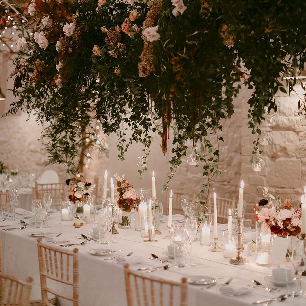 Dramatic floral hanging arrangement above tablescape