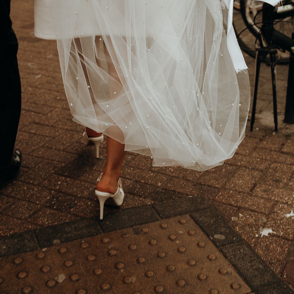 bride-in-short-wedding-dress-with-white-bridal-shoes