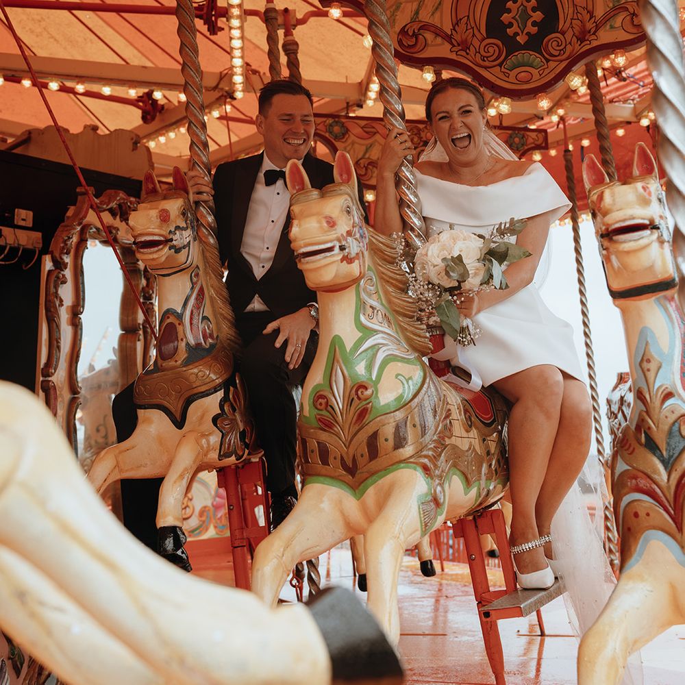 couple-on-carousel-at-seaside-coastal-wedding