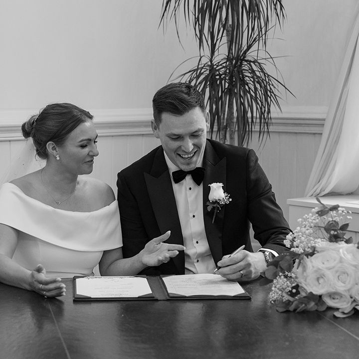 couple-signing-wedding-register