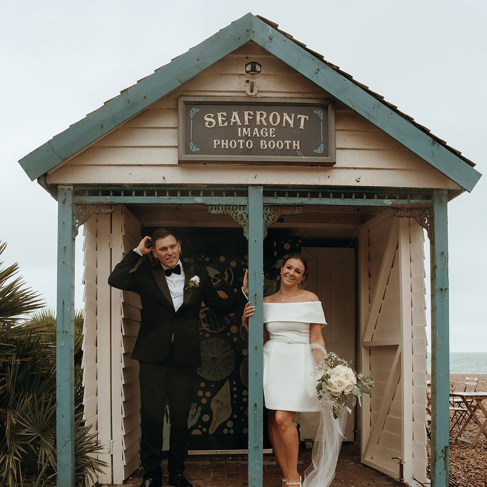 couple-standing-in-seafront-hut-for-coastal-registry-office-wedding