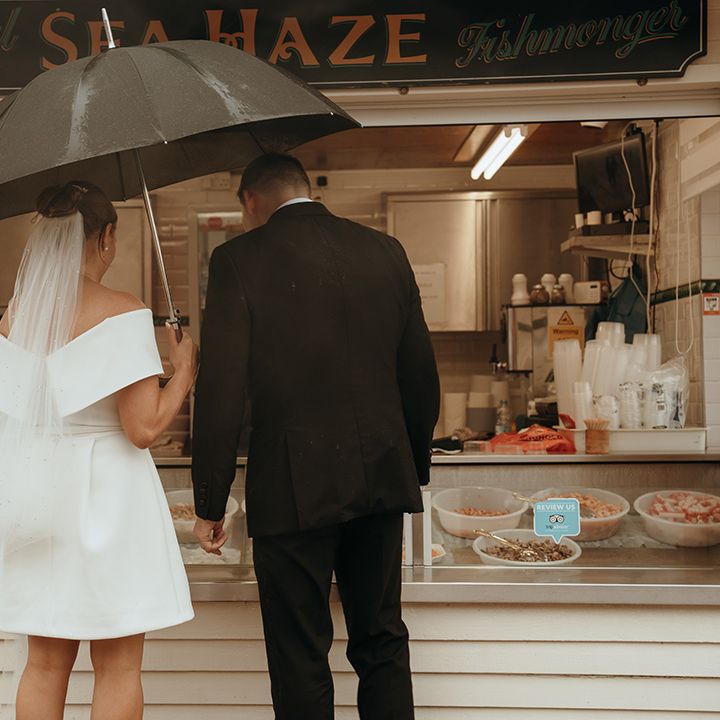couple-under-umbrella-at-fish-and-chip-stall