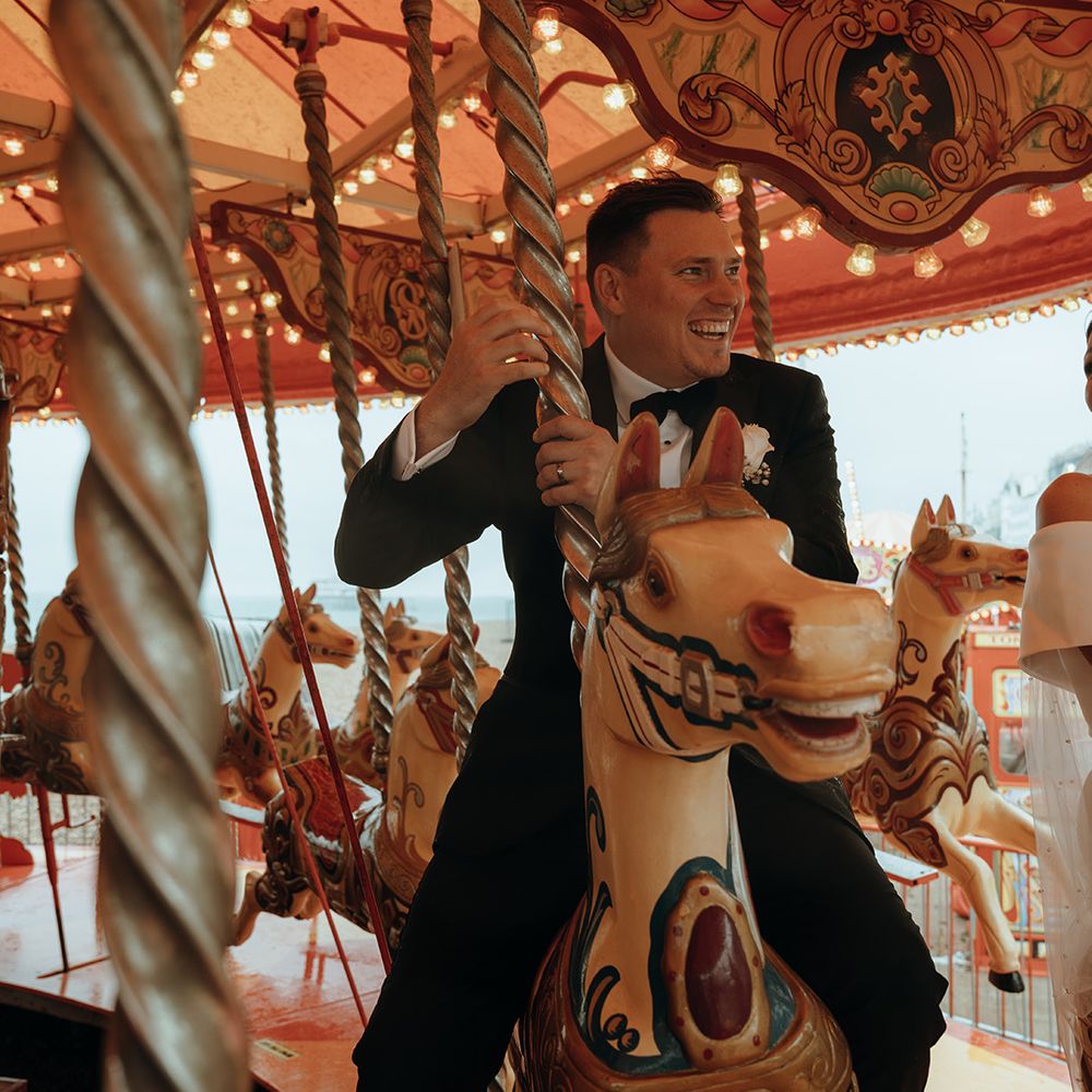 groom-on-carousel-at-coastal-wedding