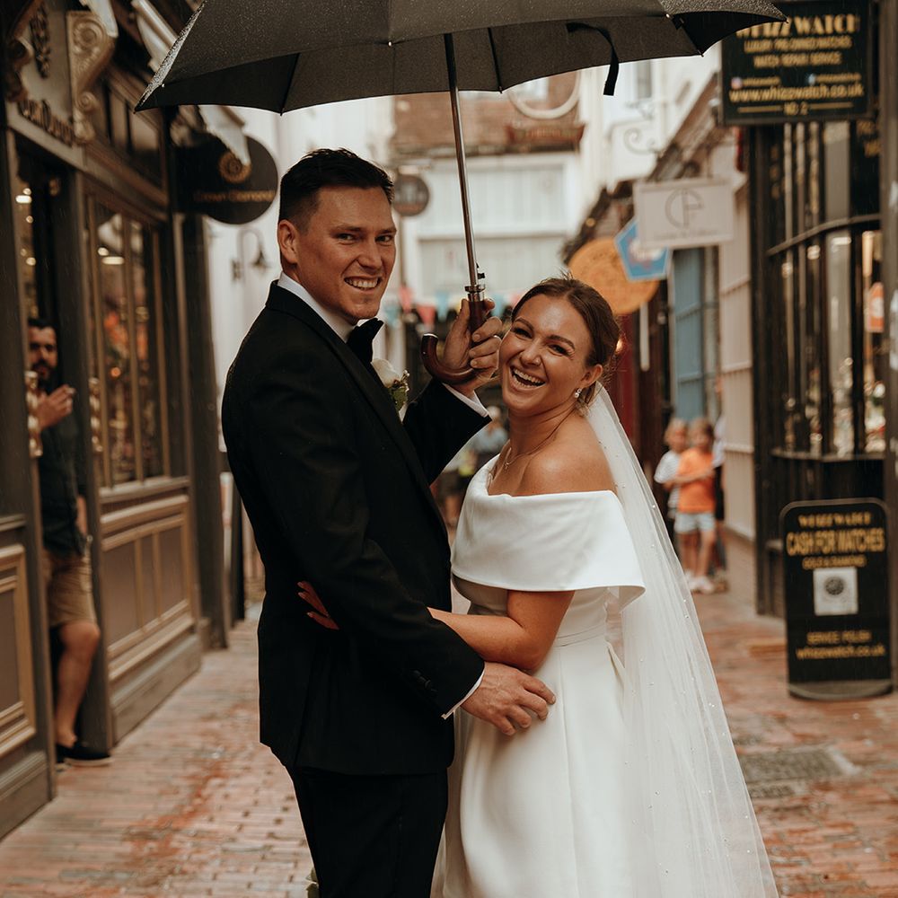 rainy-wedding-day-with-groom-wearing-black-tuxedo-and-bride-in-short-wedding-dress