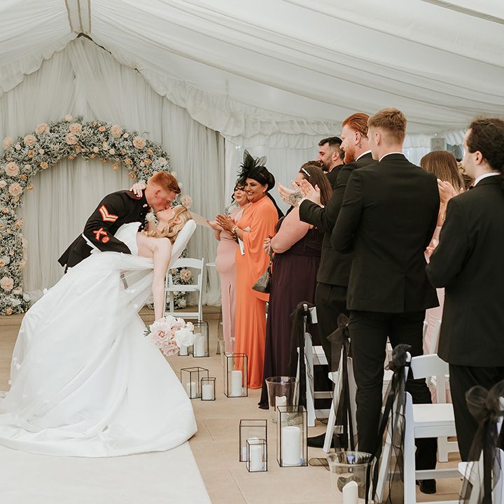 bride-and-groom-share-a-kiss-walking-back-down-the-aisle-as-married-couple