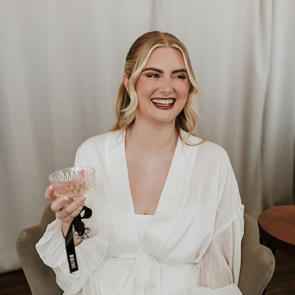 bride-in-white-robe-getting-ready-for-wedding